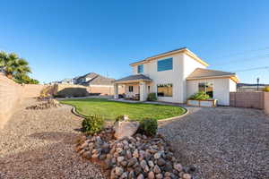 Back of house featuring a fenced backyard, a patio area, and stucco siding