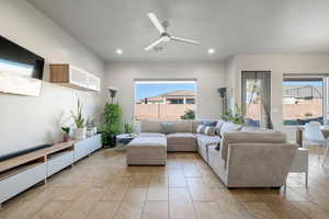 Living area featuring ceiling fan, recessed lighting, and light tile patterned flooring