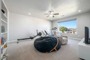 Workout room with carpet, a ceiling fan, recessed lighting, and a textured ceiling