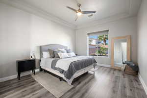 Bedroom featuring wood finished floors, a ceiling fan, and crown molding