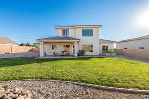 Back of house featuring a fenced backyard, stucco siding, and a patio