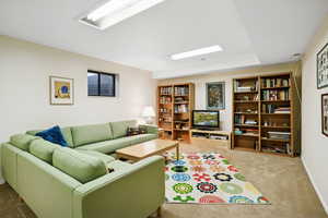 Carpeted living room with baseboards