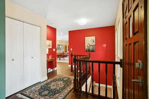 Entrance foyer featuring dark wood-style floors and baseboards