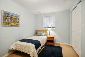 Carpeted bedroom with a closet and a textured ceiling