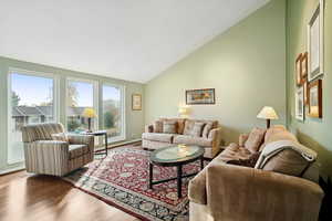 Living area featuring hardwood / wood-style flooring and high vaulted ceiling