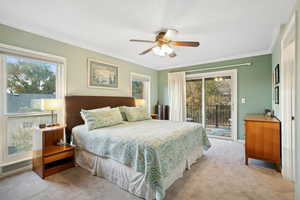 Carpeted bedroom featuring access to exterior, ornamental molding, and ceiling fan