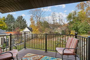 Deck featuring view of wooded area