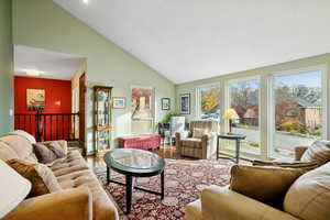 Living room with wood finished floors and high vaulted ceiling