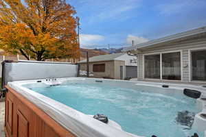 View of pool with a hot tub