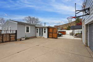 Rear view of property featuring a patio, a mountain view, french doors, and a gate