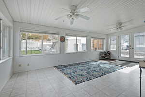 Sunroom / solarium featuring french doors and healthy amount of natural light