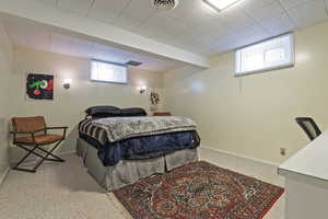 Bedroom featuring baseboards and light colored carpet
