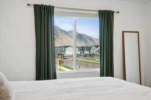 Bedroom featuring a residential view and a mountain view