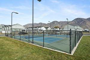 View of tennis court featuring a residential view and a mountain view