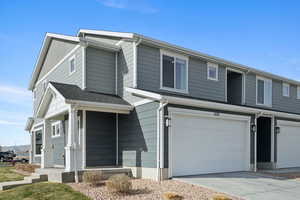 View of front facade with a garage and concrete driveway