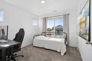 Bedroom featuring a desk and carpet