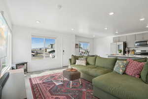 Living area with healthy amount of natural light, light wood-style flooring, and recessed lighting