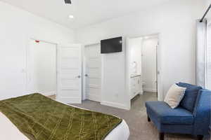 Bedroom featuring light carpet, connected bathroom, a ceiling fan, and recessed lighting