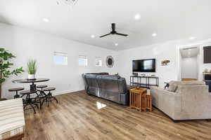 Living area with recessed lighting, light wood-style flooring, and ceiling fan
