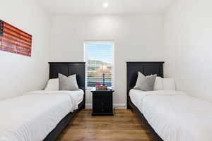 Bedroom with wood finished floors and recessed lighting