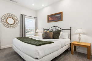 Carpeted bedroom with baseboards and recessed lighting