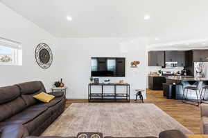 Living area featuring light wood-style floors and recessed lighting