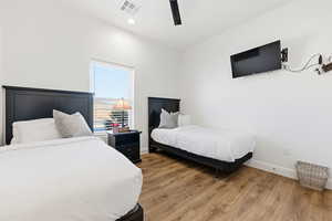 Bedroom featuring wood finished floors, ceiling fan, and recessed lighting