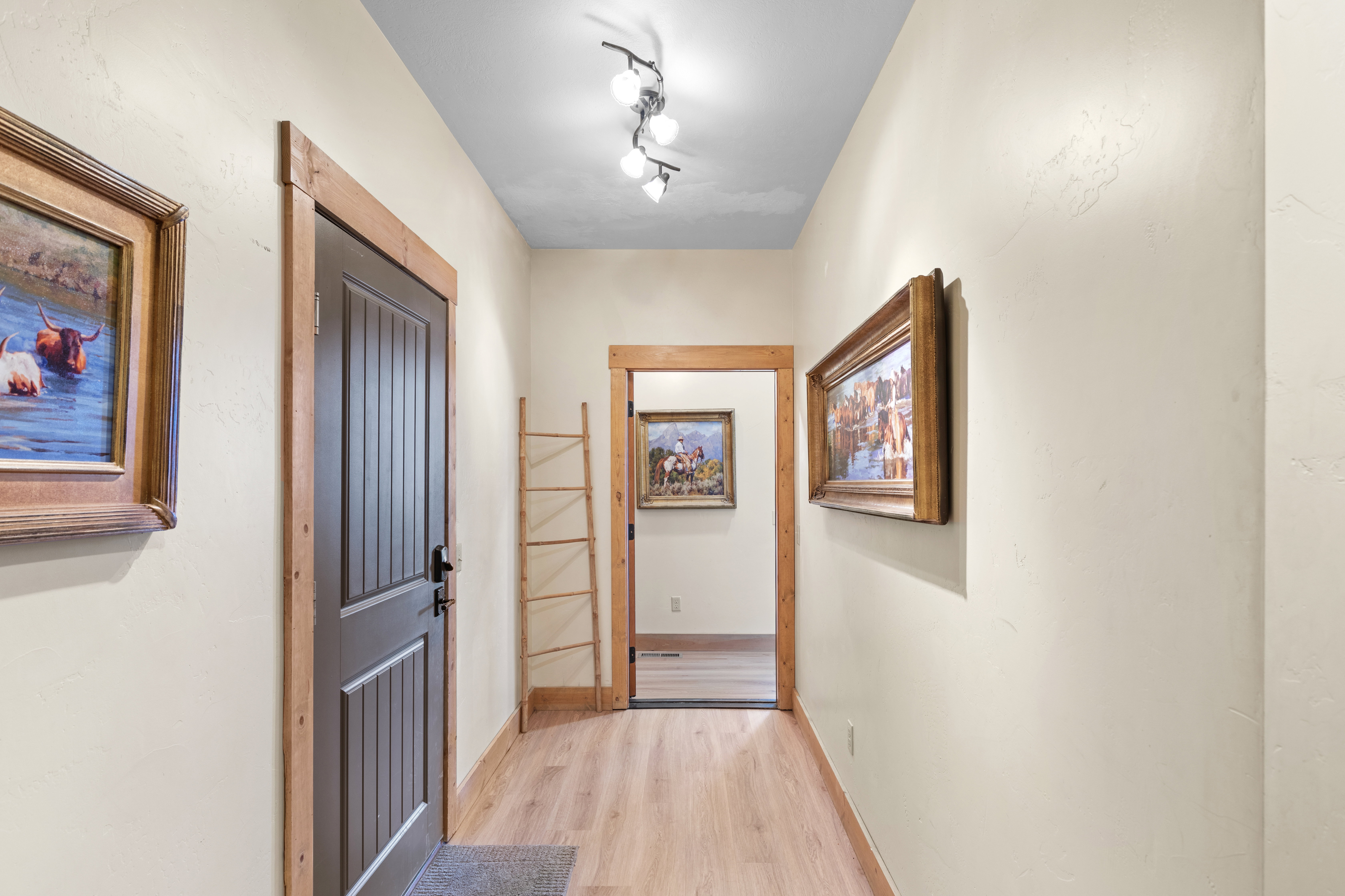 Corridor featuring light wood finished floors and baseboards
