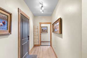 Corridor featuring light wood finished floors and baseboards