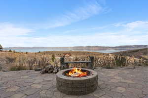 View of patio / terrace with a water and mountain view