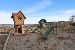 View of jungle gym featuring a mountain view