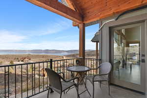 Balcony featuring a water and mountain view