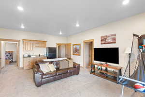 Living room with light colored carpet and recessed lighting