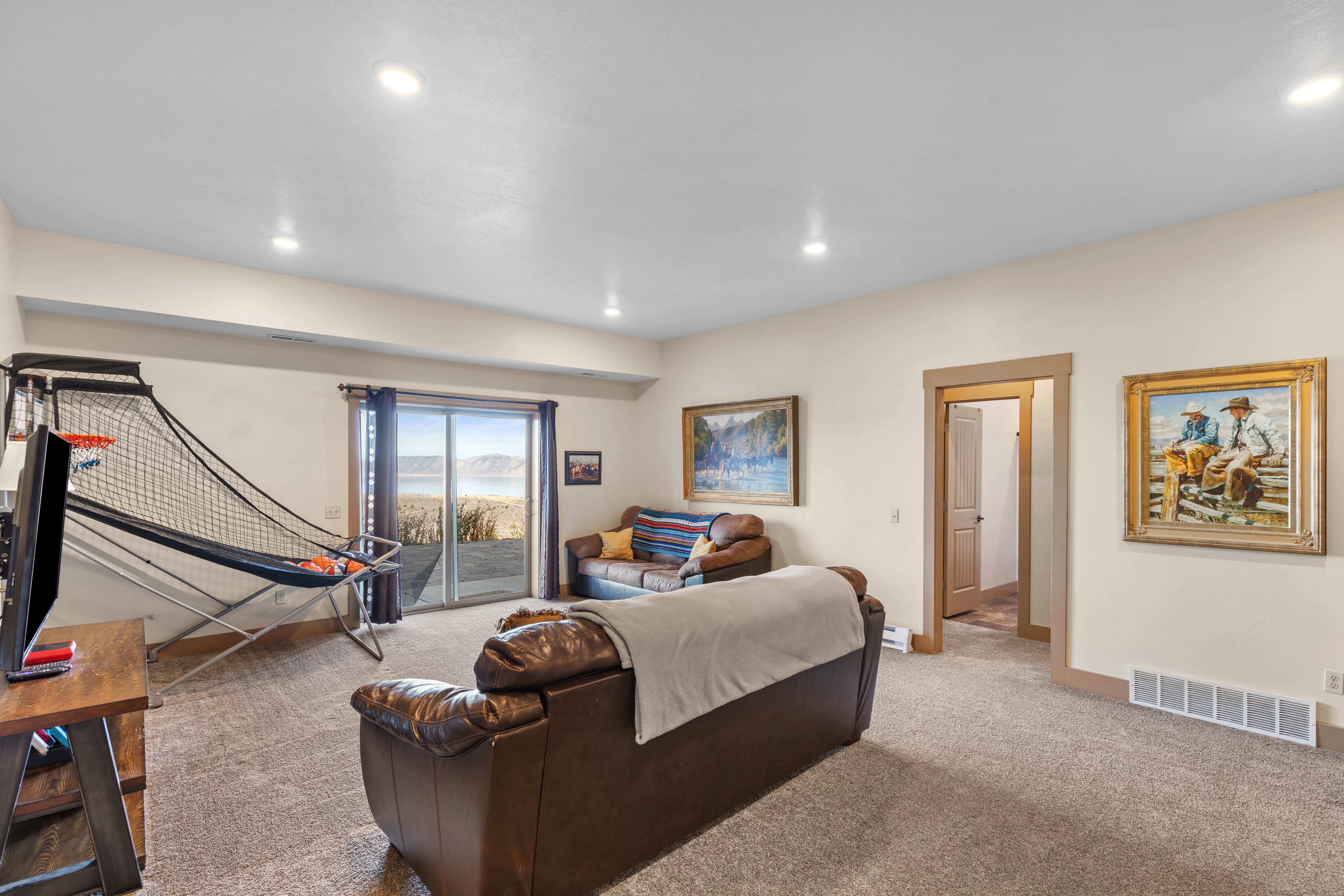 Living area with carpet floors and recessed lighting