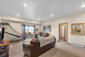 Living area with carpet floors and recessed lighting
