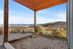 View of patio / terrace with a water and mountain view