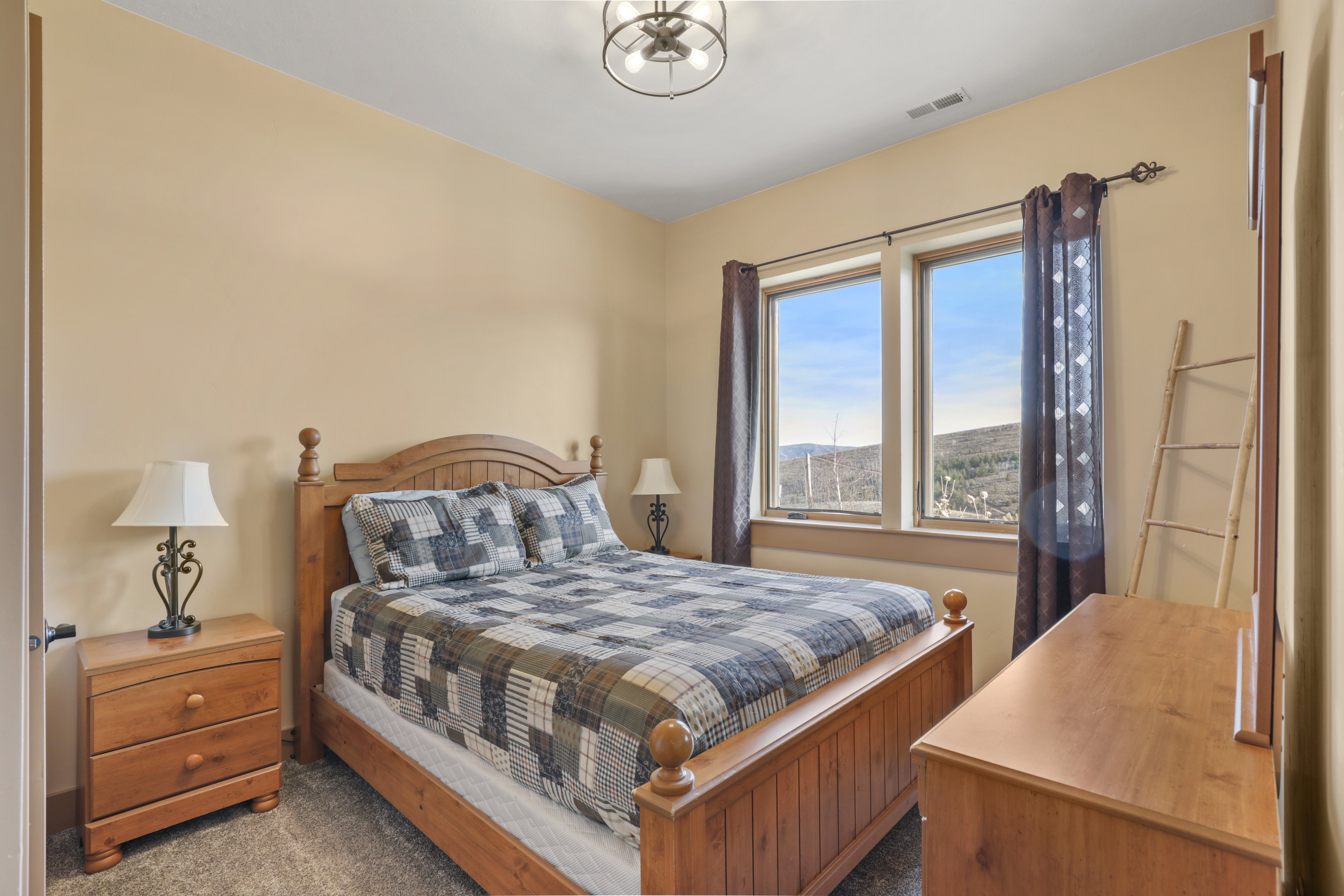 Bedroom featuring dark colored carpet and a mountain view