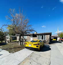 Ranch-style home featuring brick siding and a chimney
