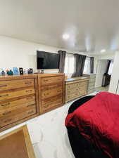 Bedroom with light marble finish flooring