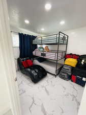 Bedroom with marble finish flooring and recessed lighting