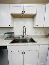 Kitchen with white cabinets and stainless steel dishwasher