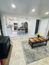 Living area with a wood stove and recessed lighting