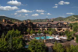 Community pool with a mountain view, a residential view, and a patio area