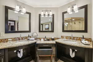 Full bathroom featuring tasteful backsplash, vanity, a shower stall, and light tile patterned floors