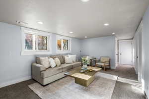 Living area featuring carpet and recessed lighting