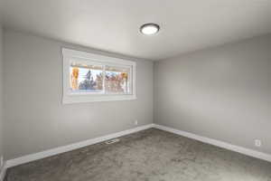 Spare room with carpet floors and baseboards