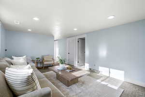 Carpeted living room featuring recessed lighting