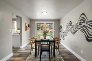 Dining area featuring a textured ceiling and vinyl flooring