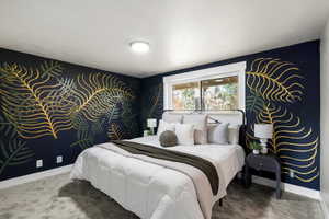 Carpeted bedroom with baseboards and a textured ceiling