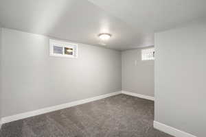 Basement with baseboards and carpet flooring